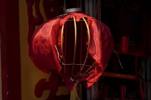 Partially destroyed lantern in a shop doorway in Malaka