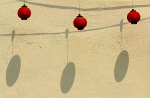 Lanterns and shadows in an alley in Malaka